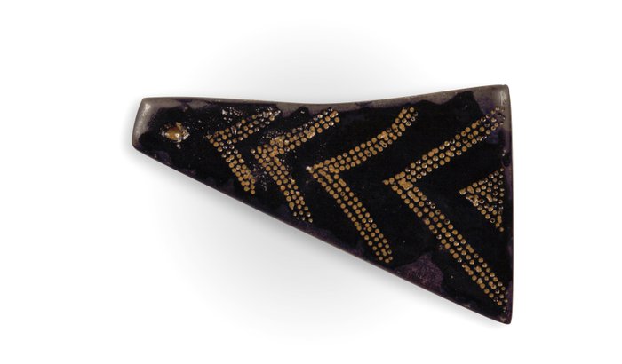 Decorated jet spacer plate from bead necklace, showing chevron-shaped design